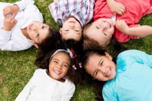 Children lying in a field